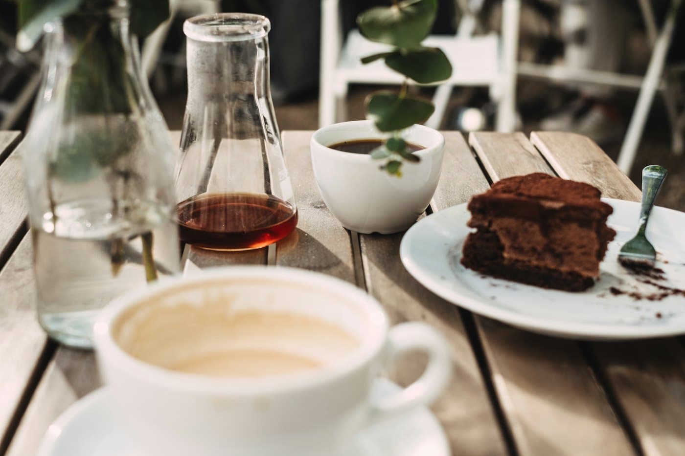 Brownies on a plate next to a cup of coffee